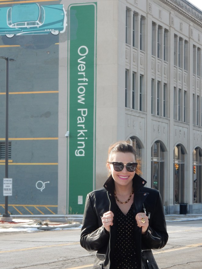 Sarah In Style, SarahInStyle.com, Sarah Meyer, Chicago Fashion Blogger, Michigan Fashion Blogger, Midwest Fashion Blogger, Flint Michigan, Downtown Flint, Flint MI, Michigan Cities, Leather Moto Jacket, Topshop Moto Jacket, J. Crew Black and Gold Polka Dot Dress, Pink and Black Studded Purse, Capitol Theater Flint, Kate Spade Sunglasses, Kate Spade Heart Ring, Gold Heart Ring, Tres Colori, Custom Rings, Year Ring, Chunky Gold Rings, Chunky Gold Necklace, Chunky Gold Jewelry, Shine Bright in Fashion, Shine Bright, Who What Wear, What to Wear, Outfit of the Day, 90's grunge fashion, 90's punk fashion, 90's fashion back in style, everything comes back into style, what goes around comes around