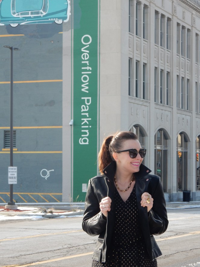 Sarah In Style, SarahInStyle.com, Sarah Meyer, Chicago Fashion Blogger, Michigan Fashion Blogger, Midwest Fashion Blogger, Flint Michigan, Downtown Flint, Flint MI, Michigan Cities, Leather Moto Jacket, Topshop Moto Jacket, J. Crew Black and Gold Polka Dot Dress, Pink and Black Studded Purse, Capitol Theater Flint, Kate Spade Sunglasses, Kate Spade Heart Ring, Gold Heart Ring, Tres Colori, Custom Rings, Year Ring, Chunky Gold Rings, Chunky Gold Necklace, Chunky Gold Jewelry, Shine Bright in Fashion, Shine Bright, Who What Wear, What to Wear, Outfit of the Day, 90's grunge fashion, 90's punk fashion, 90's fashion back in style
