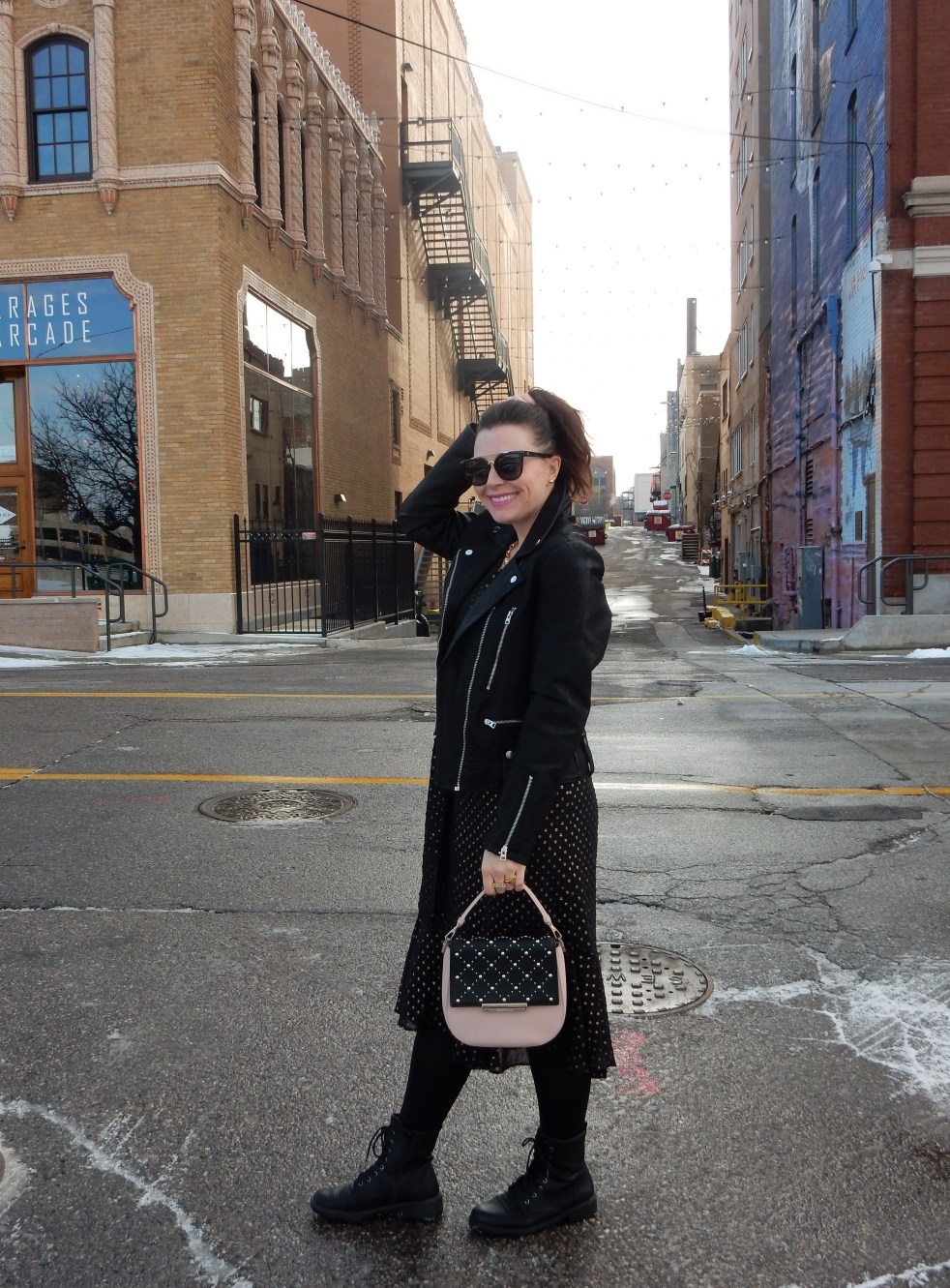 Sarah In Style, SarahInStyle.com, Sarah Meyer, Chicago Fashion Blogger, Michigan Fashion Blogger, Midwest Fashion Blogger, Flint Michigan, Downtown Flint, Flint MI, Michigan Cities, Leather Moto Jacket, Topshop Moto Jacket, J. Crew Black and Gold Polka Dot Dress, Pink and Black Studded Purse, Capitol Theater Flint, Kate Spade Sunglasses, Kate Spade Heart Ring, Gold Heart Ring, Tres Colori, Custom Rings, Year Ring, Chunky Gold Rings, Chunky Gold Necklace, Chunky Gold Jewelry, Shine Bright in Fashion, Shine Bright, Who What Wear, What to Wear, Outfit of the Day, 90's grunge fashion, 90's punk fashion, 90's fashion back in style