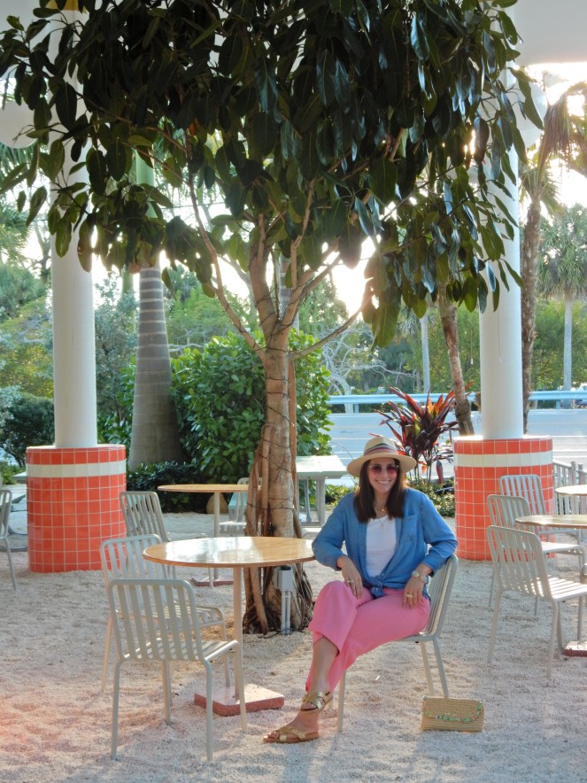 Sarah In Style, SarahInStyle, SarahInStyle.com, Sarah Meyer, Fashion Blog, Fashion Blogger, Chicago Fashion Blogger, Florida Fashion Blogger, Fashion Inspiration from blogs, What to wear in spring, Spring 2021 Fashion, Spring 2021 Fashion Trends, Styling bright pants, pink pants, colorful spring pants, colorful spring wardrobe, classic chambray button down, joules hat, pink sunglasses, lilly pulitzer sandals, gold criss cross sandals, chunky gold jewelry, fashion inspiration for spring, what to wear in Florida in spring, Whitney's Florida, Whitney's Longboat Key, retro fashion shoot, mid-century modern in Florida, Classic spring looks, Classic spring fashion, styling tips from bloggers, retro gas station, best restaurants in Sarasota, mid-centruy sarasota