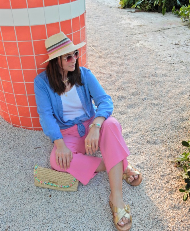 Sarah In Style, SarahInStyle, SarahInStyle.com, Sarah Meyer, Fashion Blog, Fashion Blogger, Chicago Fashion Blogger, Florida Fashion Blogger, Fashion Inspiration from blogs, What to wear in spring, Spring 2021 Fashion, Spring 2021 Fashion Trends, Styling bright pants, pink pants, colorful spring pants, colorful spring wardrobe, classic chambray button down, joules hat, pink sunglasses, lilly pulitzer sandals, gold criss cross sandals, chunky gold jewelry, fashion inspiration for spring, what to wear in Florida in spring, Whitney's Florida, Whitney's Longboat Key, retro fashion shoot, mid-century modern in Florida, Classic spring looks, Classic spring fashion, styling tips from bloggers