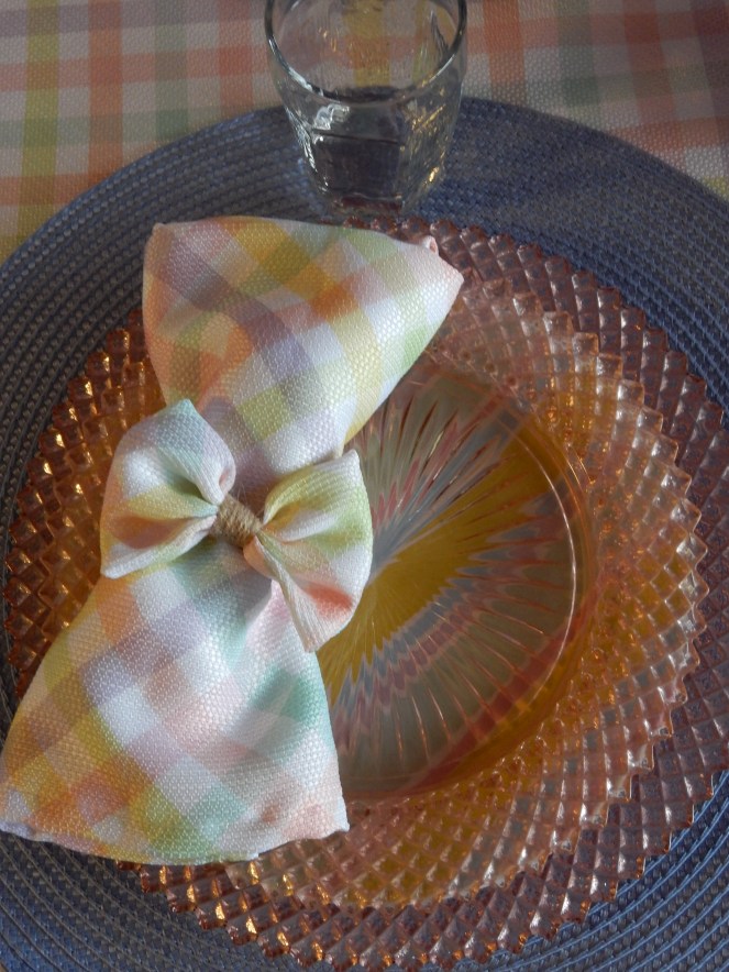 Sarah In Style, SarahInStyle.com, Sarah Meyer, Dining Decor, Hoppy Easter, Easter Table, Easter Decorating, Easter Decorations, Easter tablescapes, Spring tablescapes, spring tablescape, decorating for Easter, incorporating family traditions, where did the easter bunny originate, where is the easter bunny from, why do we hide easter eggs, cute table decor, miss america depressrion glass, pink miss america glass, plaid tablecloth, plaid napkins, bow napkin rings, table decorating ideas, wedding shower tables, baby shower tables, springtime decor. Easter 2021, Bed Bath and Beyond tableware