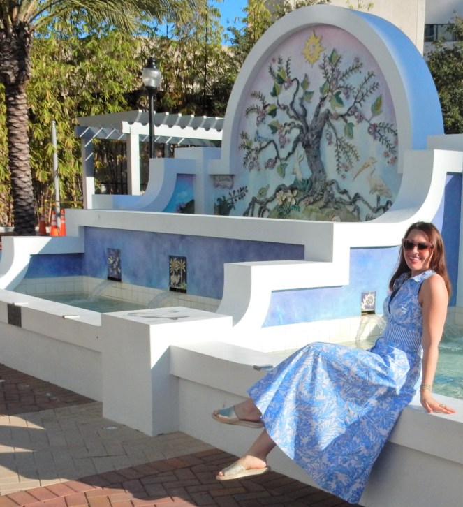 Lilly Pulitzer Mermaid Dress, Blue and White Lilly Pulitzer Dress, Lilly Pulitzer Chrisella Dress, Lilly Pulitzer mermaid print, mermaid pattern dress, Chic in blue and white, pink sunglasses, bold statement necklaces, blue and green gem necklace, Florida, fashion, Southern style, perfect country club dress, country club fashion, beach chic, perfect summer dress, belted shirt dress, most flattering dress, summer fashion 2021, summer style 2021, mermaid meaning, what do mermaids symbolize, Sarah In Style, SarahInStyle.com, Sarah Meyer, Chicago fashion blogger, fashion blogger summer style, Florida fashion blogger, Sarasota fountains, Sarasota waterfront, Sarasota blogger, adult mermaid dress