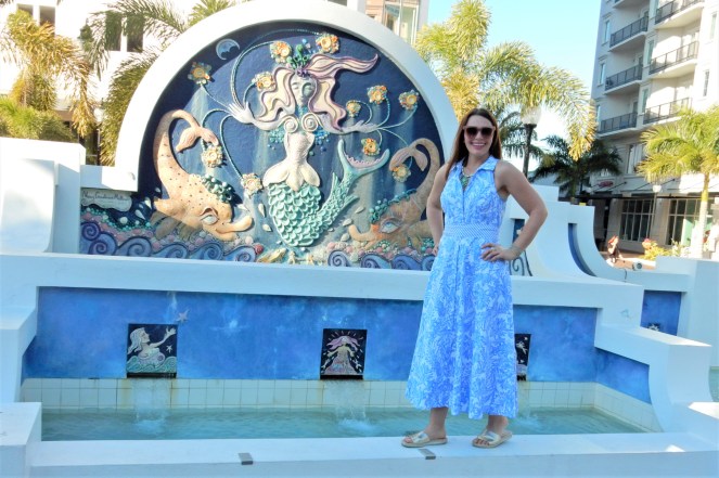 Lilly Pulitzer Mermaid Dress, Blue and White Lilly Pulitzer Dress, Lilly Pulitzer Chrisella Dress, Lilly Pulitzer mermaid print, mermaid pattern dress, Chic in blue and white, pink sunglasses, bold statement necklaces, blue and green gem necklace, Florida, fashion, Southern style, perfect country club dress, country club fashion, beach chic, perfect summer dress, belted shirt dress, most flattering dress, summer fashion 2021, summer style 2021, mermaid meaning, what do mermaids symbolize, Sarah In Style, SarahInStyle.com, Sarah Meyer, Chicago fashion blogger, fashion blogger summer style, Florida fashion blogger, Sarasota fountains, Sarasota waterfront, Sarasota blogger, adult mermaid dress