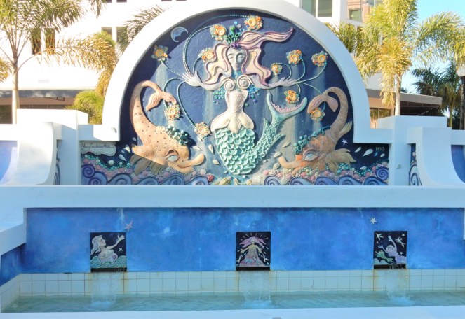 Lilly Pulitzer Mermaid Dress, Blue and White Lilly Pulitzer Dress, Lilly Pulitzer Chrisella Dress, Lilly Pulitzer mermaid print, mermaid pattern dress, Chic in blue and white, pink sunglasses, bold statement necklaces, blue and green gem necklace, Florida, fashion, Southern style, perfect country club dress, country club fashion, beach chic, perfect summer dress, belted shirt dress, most flattering dress, summer fashion 2021, summer style 2021, mermaid meaning, what do mermaids symbolize, Sarah In Style, SarahInStyle.com, Sarah Meyer, Chicago fashion blogger, fashion blogger summer style, Florida fashion blogger, Sarasota fountains, Sarasota waterfront, Sarasota blogger, adult mermaid dress