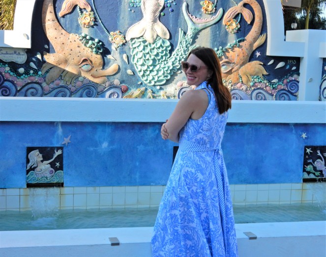 Lilly Pulitzer Mermaid Dress, Blue and White Lilly Pulitzer Dress, Lilly Pulitzer Chrisella Dress, Lilly Pulitzer mermaid print, mermaid pattern dress, Chic in blue and white, pink sunglasses, bold statement necklaces, blue and green gem necklace, Florida, fashion, Southern style, perfect country club dress, country club fashion, beach chic, perfect summer dress, belted shirt dress, most flattering dress, summer fashion 2021, summer style 2021, mermaid meaning, what do mermaids symbolize, Sarah In Style, SarahInStyle.com, Sarah Meyer, Chicago fashion blogger, fashion blogger summer style, Florida fashion blogger, Sarasota fountains, Sarasota waterfront, Sarasota blogger, adult mermaid dress