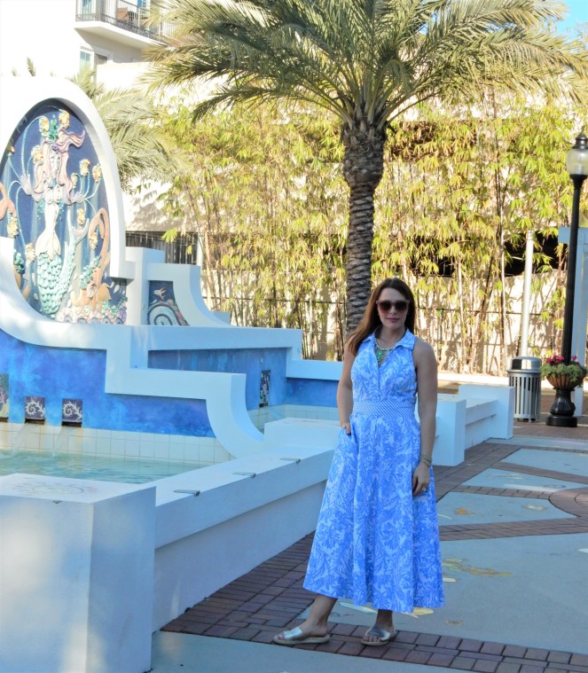 Lilly Pulitzer Mermaid Dress, Blue and White Lilly Pulitzer Dress, Lilly Pulitzer Chrisella Dress, Lilly Pulitzer mermaid print, mermaid pattern dress, Chic in blue and white, pink sunglasses, bold statement necklaces, blue and green gem necklace, Florida, fashion, Southern style, perfect country club dress, country club fashion, beach chic, perfect summer dress, belted shirt dress, most flattering dress, summer fashion 2021, summer style 2021, mermaid meaning, what do mermaids symbolize, Sarah In Style, SarahInStyle.com, Sarah Meyer, Chicago fashion blogger, fashion blogger summer style, Florida fashion blogger, Sarasota fountains, Sarasota waterfront, Sarasota blogger, adult mermaid dress