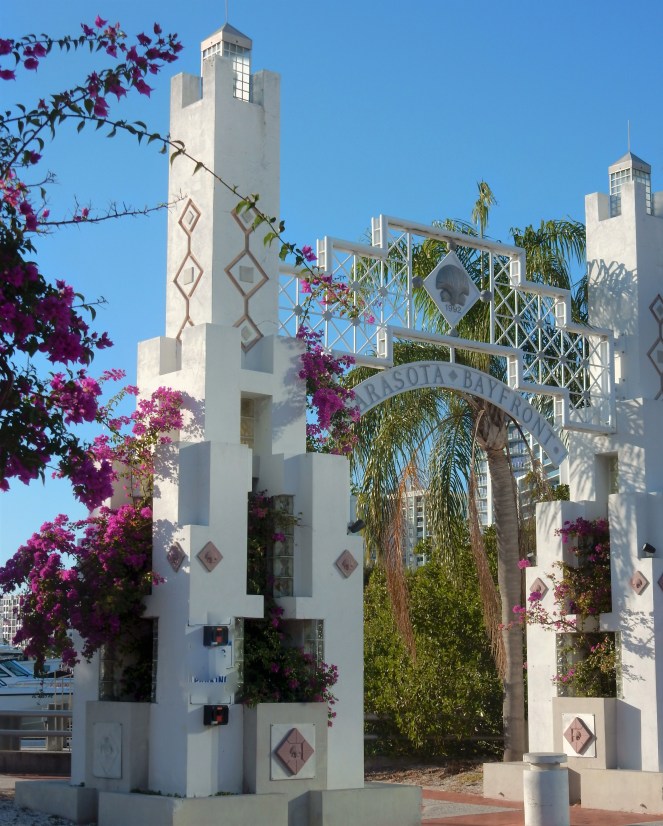 Lilly Pulitzer Mermaid Dress, Blue and White Lilly Pulitzer Dress, Lilly Pulitzer Chrisella Dress, Lilly Pulitzer mermaid print, mermaid pattern dress, Chic in blue and white, pink sunglasses, bold statement necklaces, blue and green gem necklace, Florida, fashion, Southern style, perfect country club dress, country club fashion, beach chic, perfect summer dress, belted shirt dress, most flattering dress, summer fashion 2021, summer style 2021, mermaid meaning, what do mermaids symbolize, Sarah In Style, SarahInStyle.com, Sarah Meyer, Chicago fashion blogger, fashion blogger summer style, Florida fashion blogger, Sarasota fountains, Sarasota waterfront, Sarasota blogger, adult mermaid dress