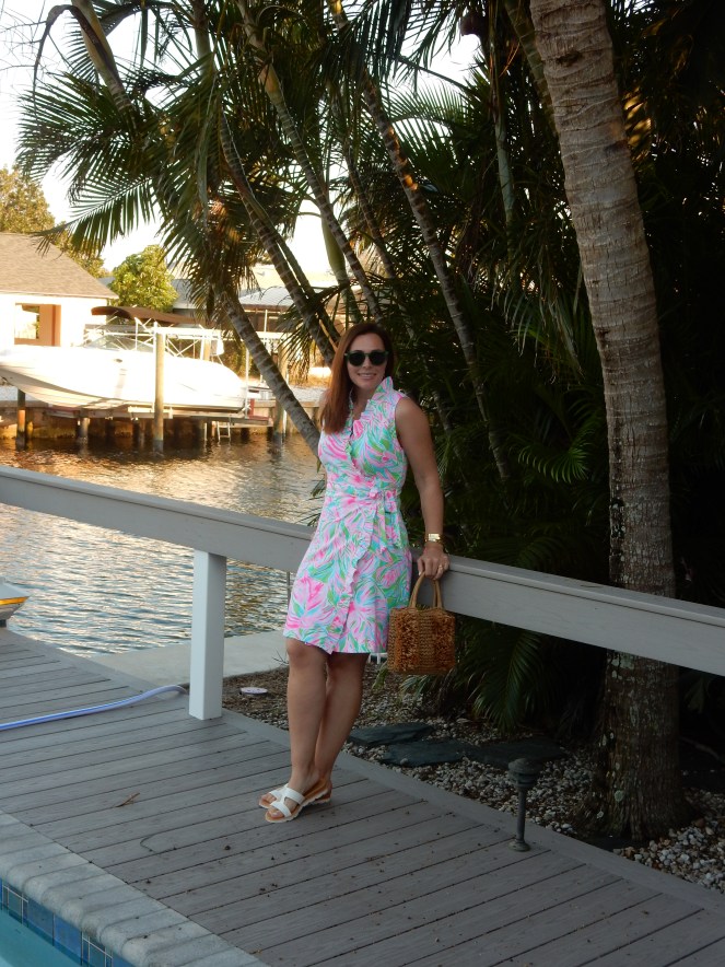 Wrapped in Summer, Lilly Wrap Dress, Lilly Pulitzer Wrap Dress, Mod Fashion, 1960's Fashion, 60s Fashion, Retro Fashion Inspiration, Lilly Pulitzer Print, Lilly Pulitzer History, Green Sunglasses, Lilly Pulitzer Bracelets, Fringe Straw Purse, Fringe Straw Bag, Mod Sandals, Block Sandals, Florida Fashion, Summer Style, Summer 2021 Fashion, Classic Summer Style, Classic Summer Fashion, Blogger Fashion Tips, What to Wear This Summer, What She Wore, Sarah Meyer, SarahInStyle.com, Sarah In Style, Tropical Fashion, Perfect Summer Style, Florida Fashion Blogger, Chicago Fashion Blogger, Loft Purse Sunglass Warehouse, Mermaid Ring, Alex and Ani Ring