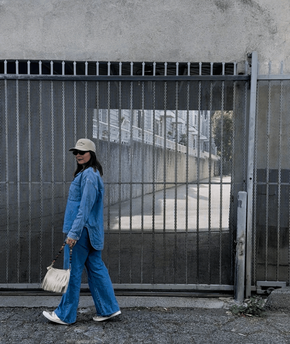 Woman wearing a matching denim set styled as a chic and comfortable travel outfit.